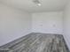 Bright bedroom with gray wood-look floors, white walls, and two white doors at 14014 N 39Th Ave, Phoenix, AZ 85053