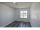 Bedroom featuring a window overlooking the neighborhood and stylish wood-look flooring at 14014 N 39Th Ave, Phoenix, AZ 85053