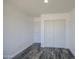 A well-lit bedroom features dark wood-look floors and a spacious closet with white sliding doors at 14014 N 39Th Ave, Phoenix, AZ 85053
