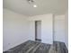 This bedroom features wood-look flooring, closet with sliding doors, and a standard door at 14014 N 39Th Ave, Phoenix, AZ 85053