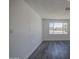 Bright bedroom with gray wood-look floors and a large window with neighborhood views at 14014 N 39Th Ave, Phoenix, AZ 85053