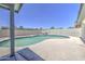 Backyard pool with surrounding deck, privacy wall, and covered patio at 14014 N 39Th Ave, Phoenix, AZ 85053