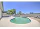 Backyard pool with surrounding deck, desert landscaping, and covered patio at 14014 N 39Th Ave, Phoenix, AZ 85053