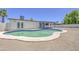 Backyard Oasis featuring a kidney-shaped pool, desert landscaping, and a covered patio, creating a perfect outdoor retreat at 14014 N 39Th Ave, Phoenix, AZ 85053