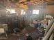 Messy garage space with exposed framework, windows, and overflowing with storage items at 14214 N 36Th Ave, Phoenix, AZ 85053