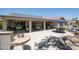 Large backyard with solar panels, covered patio, grill, and water feature for luxurious outdoor living at 15953 W Catalina Dr, Goodyear, AZ 85395