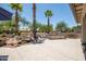 Beautiful backyard features a waterfall, built-in grill, and desert landscaping for a tranquil outdoor experience at 15953 W Catalina Dr, Goodyear, AZ 85395