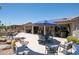 Expansive backyard features multiple seating areas, outdoor kitchen, and water feature for the ultimate outdoor living at 15953 W Catalina Dr, Goodyear, AZ 85395