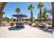 Lush backyard with a rock waterfall, mature landscaping, and comfortable seating is perfect for entertaining guests at 15953 W Catalina Dr, Goodyear, AZ 85395