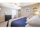 Bedroom featuring a ceiling fan, modern décor, wooden floors, and plenty of natural light at 15953 W Catalina Dr, Goodyear, AZ 85395