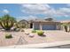 Charming single-story home featuring a three-car garage, desert landscaping, and a neutral color palette at 15953 W Catalina Dr, Goodyear, AZ 85395