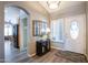 Welcoming foyer showcasing arched doorway, modern floors, and stylish entryway decor at 15953 W Catalina Dr, Goodyear, AZ 85395