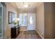 Bright foyer with new flooring, decorative mirror, and a view of the front door at 15953 W Catalina Dr, Goodyear, AZ 85395