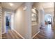 Well-lit hallway with wood laminate flooring, archways, and neutral wall colors at 15953 W Catalina Dr, Goodyear, AZ 85395