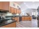 Well-lit kitchen with gas stove, black appliances, plenty of wooden cabinets, and lots of counter space at 15953 W Catalina Dr, Goodyear, AZ 85395