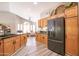 Bright and airy kitchen features wood cabinets, stainless steel appliances, and a breakfast bar overlooking a cozy sitting area at 15953 W Catalina Dr, Goodyear, AZ 85395