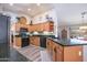 Spacious kitchen showcasing wooden cabinets, black granite countertops, and sleek appliances, perfect for culinary enthusiasts at 15953 W Catalina Dr, Goodyear, AZ 85395