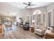 Spacious living room area featuring vaulted ceilings, many windows, and wood laminate flooring at 15953 W Catalina Dr, Goodyear, AZ 85395