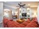 Inviting living room features a large sectional sofa and custom built-in entertainment center with decorative shelving at 15953 W Catalina Dr, Goodyear, AZ 85395