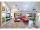 Spacious living room featuring custom built-ins, a large sectional sofa, and hardwood flooring at 15953 W Catalina Dr, Goodyear, AZ 85395