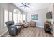 Inviting living room with hardwood floors, lots of natural light, comfortable seating, and tasteful decorations at 15953 W Catalina Dr, Goodyear, AZ 85395