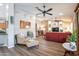 Open living space with hardwood floors, modern decor, and a comfortable seating area by the entertainment center at 15953 W Catalina Dr, Goodyear, AZ 85395