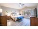 Comfortable main bedroom with vaulted ceiling, with ceiling fan and natural light at 15953 W Catalina Dr, Goodyear, AZ 85395
