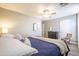 Bright main bedroom with ceiling fan, hard surface floors, and plenty of natural light at 15953 W Catalina Dr, Goodyear, AZ 85395