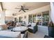 Large covered patio featuring stylish outdoor furniture, ceiling fans, and relaxing backyard views at 15953 W Catalina Dr, Goodyear, AZ 85395