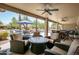 Spacious covered patio with a ceiling fan and lots of comfortable outdoor seating at 15953 W Catalina Dr, Goodyear, AZ 85395