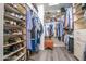 Well-organized walk-in closet with custom shelving, hanging racks, shoe rack, and wood floors at 15953 W Catalina Dr, Goodyear, AZ 85395