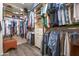 Well-organized walk-in closet with custom shelving, hanging racks, and wood floors for ample storage at 15953 W Catalina Dr, Goodyear, AZ 85395