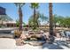 Backyard waterfall feature with lush landscaping and seating area provides a serene outdoor retreat at 15953 W Catalina Dr, Goodyear, AZ 85395