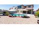 Spacious backyard with a private pool, decorative rock, lounge chairs and manicured landscaping at 19461 N Rose Rd, Maricopa, AZ 85138