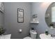 Stylish half bathroom with modern fixtures, decor, and neutral gray paint at 19461 N Rose Rd, Maricopa, AZ 85138