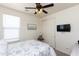 Cozy bedroom featuring a ceiling fan, built-in storage, and TV at 19461 N Rose Rd, Maricopa, AZ 85138