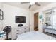 Well-lit bedroom with a dresser and a mounted TV at 19461 N Rose Rd, Maricopa, AZ 85138