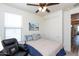 Bedroom boasts a ceiling fan, leather recliner, and ample natural light at 19461 N Rose Rd, Maricopa, AZ 85138