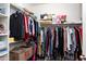 Walk-in closet well organized with an abundance of shelving and racks for clothing at 19461 N Rose Rd, Maricopa, AZ 85138