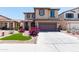 Inviting two-story home with a well-kept lawn, concrete driveway, and charming curb appeal at 19461 N Rose Rd, Maricopa, AZ 85138