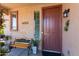 Welcoming front porch with a wooden bench, potted plants, and decorative touches by the entrance at 19461 N Rose Rd, Maricopa, AZ 85138