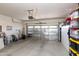 Spacious garage with storage shelving, an insulated garage door, and ample space for storage at 19461 N Rose Rd, Maricopa, AZ 85138