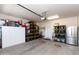 Organized garage with shelving, cabinets, refrigerator and plenty of storage space at 19461 N Rose Rd, Maricopa, AZ 85138