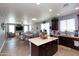 Open floor plan with a kitchen featuring dark wood cabinetry and a central island at 19461 N Rose Rd, Maricopa, AZ 85138