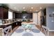 Spacious kitchen and dining area featuring dark cabinetry, stainless steel appliances, and tile flooring at 19461 N Rose Rd, Maricopa, AZ 85138