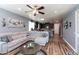 Comfortable living room featuring a sectional sofa, round coffee table, and open access to the kitchen at 19461 N Rose Rd, Maricopa, AZ 85138