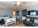 Cozy living space featuring a reclining sofa, a ceiling fan, and built in shelving at 19461 N Rose Rd, Maricopa, AZ 85138