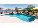 Sparkling pool with a rock waterfall feature and lush landscaping at 19461 N Rose Rd, Maricopa, AZ 85138