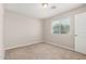 Small bedroom with neutral carpeting and a window overlooking a green space at 2000 N 36Th St # 30, Phoenix, AZ 85008