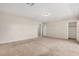Spacious bedroom featuring neutral carpeting, a ceiling light, and multiple doors at 2000 N 36Th St # 30, Phoenix, AZ 85008